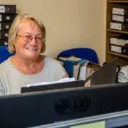 woman working behind computer